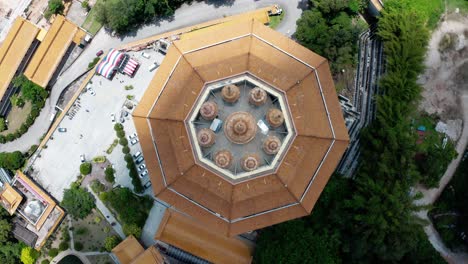 Top-view-of-Kuan-Yin-Goddess-of-Mercy-building-roof-view-in-Kek-Lok-Si-Buddhist-temple,-Aerial-drone-lift-rotation-shot