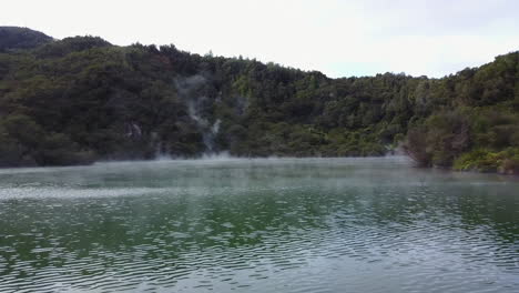 Aerial-shot-of-steaming-blue-lake-in-New-Zealand