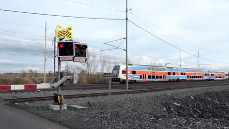Rail-crossing-with-the-lights-on-and-the-City-Elefant-train-of-the-Ceske-Drahy-company