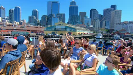 Tourists-enjoy-water-taxi-ride-with-Seattle-sights-in-background