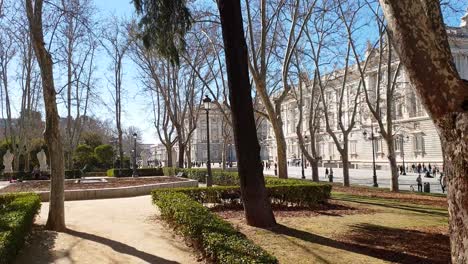 Camera-ride-through-Plaza-Oriente-overlooking-the-park-in-front-of-Palacio-Real-de-Madrid,-the-royal-palace