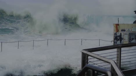 Friends-swept-by-huge-swells-to-a-pool---Bronte-Beach---Sydney-Australia