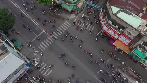 Top-down-high-angle-drone-shot-of-a-busy-intersection-watching-the-organized-chaos-of-the-of-the-Saigon-motor-cycle-traffic