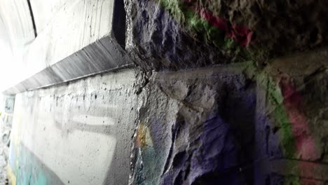Dirty-coloured-underground-rock-graffiti-artistic-walls-abstract-tags-mural-painting-dolly-left-closeup