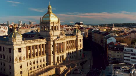 Narodni-Museum-in-Prague,-drone-flying-at-Stunning-golden-hour-sunlight-,-aerial-cityscape-at-wenceslas-square,-Czech-republic