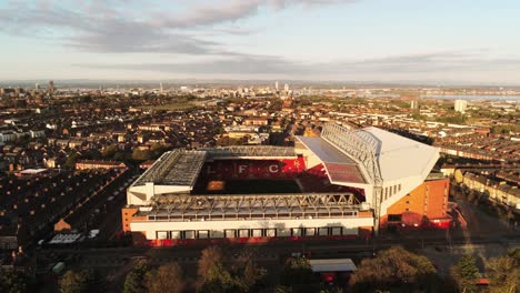 Iconic-Liverpool-Anfield-football-stadium-ground-at-sunrise-aerial-view-slow-tilt-down