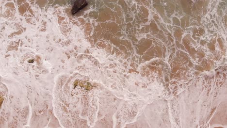 Ocean-waves-hitting-sandy-beach,-Portugal