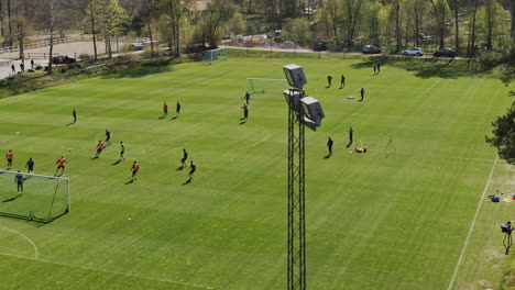 Aerial-dolly-showing-soccer-practise-on-sunny-day-in-Gothenburg-Sweden