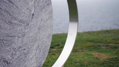 CLOSE-UP,-Phases-Of-The-Moon-Outdoor-Sculpture-On-Coastal-Foreshore
