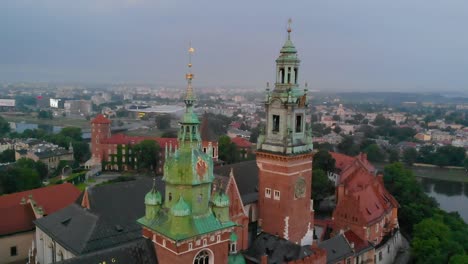 Towers-of-Wawel-Castle-and-Cathedral,-Krakow-city-panorama,-aerial-view