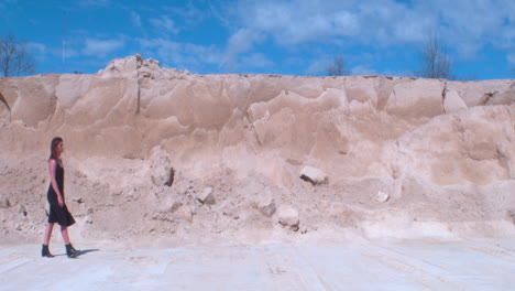 Young-Model-Plods-Through-Barren-Wasteland-Against-Huge-Sand-Mound