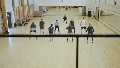 Slow-motion-dolly-shot-of-female-instructor-during-group-training