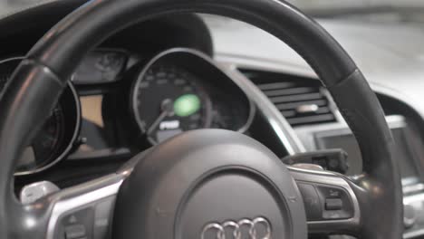 Audi-R8-Sports-Car-Steering-Wheel-and-Dashboard,-Close-Up-Approach
