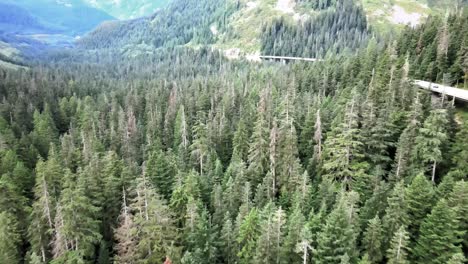 Westbound-Interstate-90-Snoqualmie-pass-snakes-through-lush-evergreen-forest,-aerial
