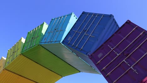 Rainbow-Sea-Container-Fremantle,-handheld-shot-under-the-colorful-arch