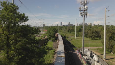 Aerial-view-of-cargo-train-heading-towards-de-city-of-Houston,-Texas,-USA