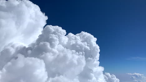 Spectacular-White-Clouds-Build-Up,-Passenger-View-from-Flying-Aircraft