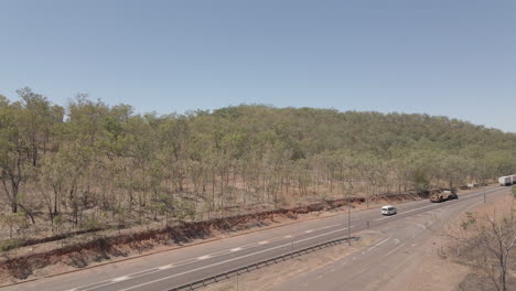Downward-moving-drone-shot-of-road-train-in-Northern-Territory,-Australian-Outback