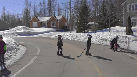 A-Kid-Smashes-a-goal-while-playing-hockey-with-his-friend-on-the-snowy-Saint-Maurice-streets