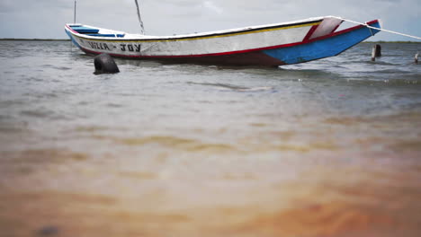 Stained-local-boat-anchored-at-the-shores-a-Africa-Senegal