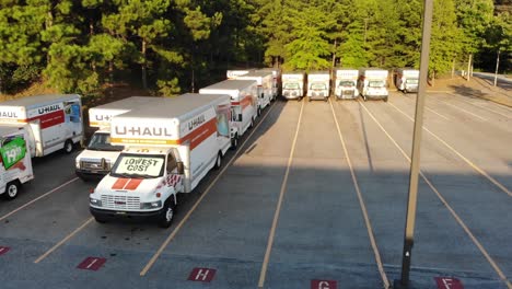 A-selection-of-Uhaul-moving-vehicles-parked-on-a-lot-at-sunset