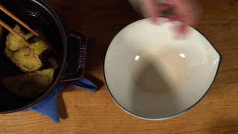 Dishing-up-deep-fried-KAMONASU-at-home-kitchen,-Tokyo,-Japan