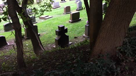 Black-tombstone-at-the-bottom-of-hill,-high-angle,-static,-Prospect-Cemetery