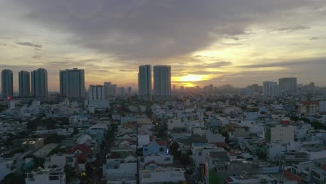 Dramatic-Truck-Drone-Sunset-shot-over-high-density-residential-area-of-Saigon,-Ho-Chi-Minh-City,-Vietnam