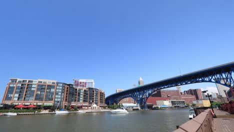 Boats,-kayaks,-jet-skis-all-coast-by-in-a-day-time-lapse-on-the-Cuyahoga-River-in-Cleveland-Ohio