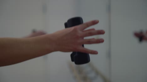 A-close-up-of-a-lady-hands-in-a-gym-exercising-of-her-hands-with-small-dumbbells-in-a-gym