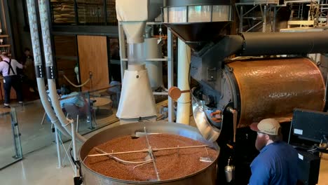 Fresh-aromatic-coffee-beans-spinning-around-a-factory-sized-coffee-roaster-at-the-Starbucks-Reserve-Seattle-Roastery