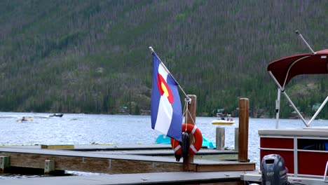 Colorado-flag-waving-by-the-Grand-Lake,-Colorado