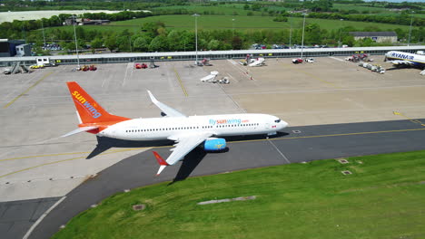 Tracking-shot-of-a-Sunwing-airplane-taxiing-to-its-arrival-terminal-gate