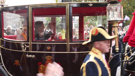 Prince-Constantijn-and-Princess-Laurentien-of-the-Dutch-royal-family-passing-by-in-horse-and-carriage-waving-at-the-crowds-along-the-pathway-from-the-House-of-Representatives-to-the-Noordeinde-Palace