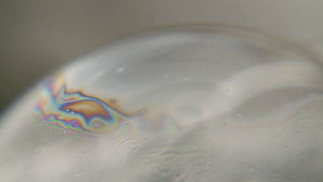 Macro-shot-of-rainbow-colored-liquid-on-a-sphere