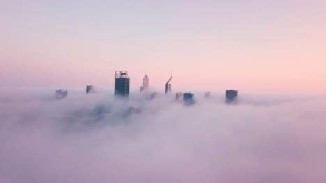 Sunrise-aerial-view-of-skyscrapers-in-Perth-rising-above-the-clouds