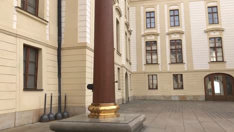 Slow-motion-of-royal-wooden-flagpole-with-golden-base-in-castle-district-of-Hradcany-in-city-of-Prague