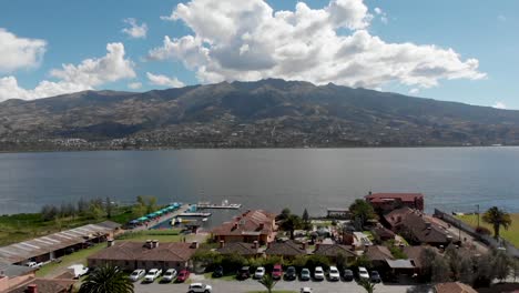 Dron-tilt-camera-move-revealing-city-and-the-Lake-San-Pablo-on-Ecuador