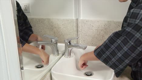 Mittlere-Aufnahme-Einer-Frau,-Die-Sich-Im-Badezimmerwaschbecken-Die-Hände-Mit-Seife-Und-Wasser-Wäscht