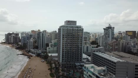Condado-Beach,-San-Juan,-Puerto-Rico,-Drone-Aerial-View-of-Hotels-and-Waterfront-on-Cloudy-Day