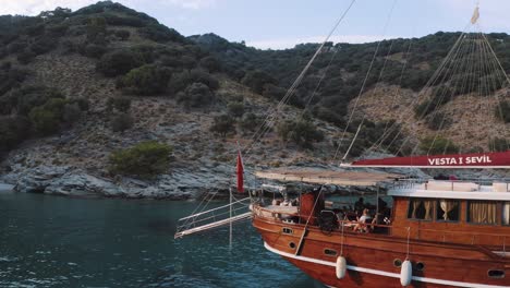 Wooden-charter-yacht-moored-in-colorful-sea-water-bay-on-Kos,-Turkey,-Aegean-coast