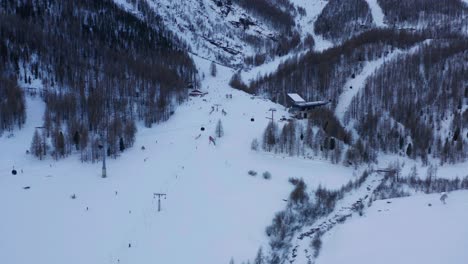Flying-up-to-ski-lifts-at-busy-resort-in-winter