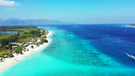 Vivid-colors-of-tropical-paradise-island-with-long-white-sandy-beach-washed-by-calm-clear-water-of-turquoise-lagoon-bordered-by-deep-blue-sea-of-Indonesia