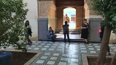 People-take-pictures-at-scenic-Bahia-Palace,-Marrakesh