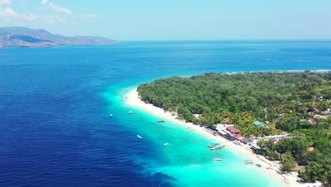 Beautiful-blue-azure-sea-around-large-tropical-island-with-long-white-beach-and-a-lot-of-resorts-with-restaurants-and-beach-bars-into-tropical-trees-forest