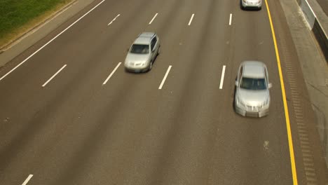 Top-down-view-of-passing-cars-on-highway