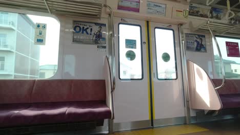 Inside-of-Japanese-train-with-bright-scenery-from-the-windows