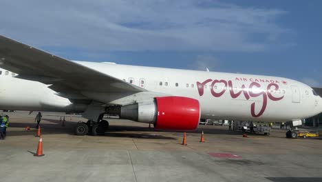 Air-Canada-passenger-jet-aircraft-is-loaded-with-luggage-and-cargo-on-tarmac