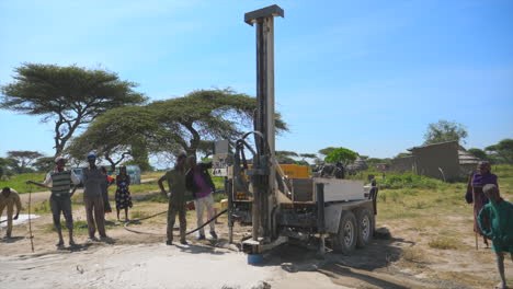 Ziway-locals-standing-around-a-rotary-drilling-machine-in-a-clear-and-sunny-day