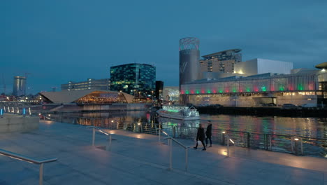 Pan-shot-of-a-pleasure-boat-in-front-of-the-lowry-center-at-Salford-keys